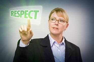 Attractive blonde woman pushing respect button on an interactive touch screen