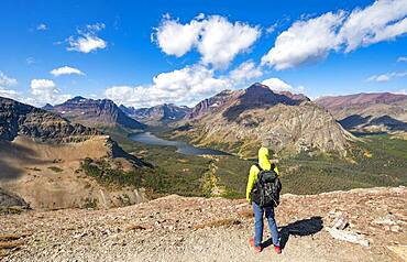 Hikers on the trail to Scenic Point, view of Two Medicine Lake, mountain peaks Rising Wolf Mountain and Sinopah Mountain, Glacier National Park, Montana, USA, North America