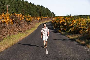 Guy walking on a road, Rotorua, Bay of Plenty, North Island, New Zealand, Oceania