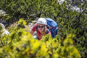 Young female hiker with helmet on the hike to the Hochkalter, Berchtesgadener Alpen, Berchtesgadener Land, Upper Bavaria, Bavaria, Germany, Europe