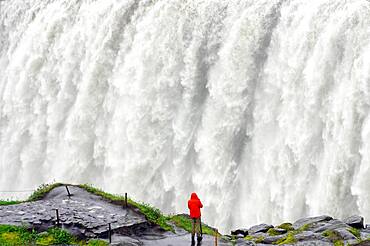 Man in front of the water masses, Dettifoss, Joekulsa a Fjoellum, Iceland, Europe