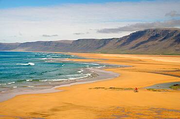 Bicycle on wide sandy beach, waves, Raudarsandur, Westfjords, Iceland, Europe