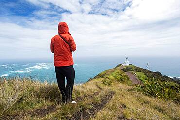 Guy infront of Cape Reinga Lighthouse, Cape Reinga, Te Rerenga Wairua, Northland, North Island, New Zealand, Oceania