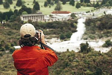 Guy with camera, Geothermal area, Redwoods Forest, Whakarewarewa, Rotorua, North Island, New Zealand, Oceania