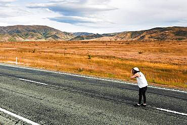 Guy with camera, Omarama, Waitaki District, Canterbury, South Island, New Zealand, Oceania