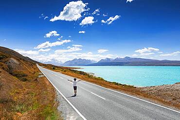 Guy on a road, Lake Pukaki, Mount Cook, Canterbury region, Mackenzie District, South Island, New Zealand, Oceania