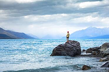 Guy at a beach at Lake Tekapo, Lake Tekapo, Canterbury region, Mackenzie District, South Island, New Zealand, Oceania