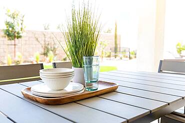 Outdoor patio setting with dishes and glasses on tray