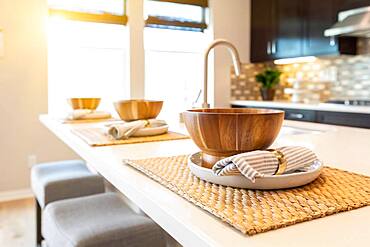 Wooden bowl place settings on kitchen island abstract