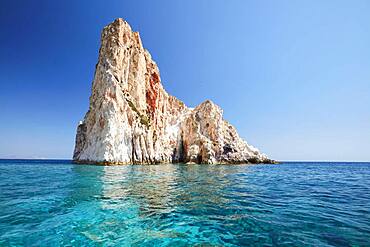 Rock rising from the water off the coast of Polyaigos next to Milos, Cyclades, Greece, Europe