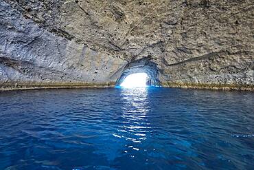 Bright blue water at the entrance to the collapsed cave Sykia, Milos, Cyclades, Greece, Europe