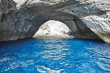 Bright blue water at the entrance to the collapsed cave Sykia, Milos, Cyclades, Greece, Europe