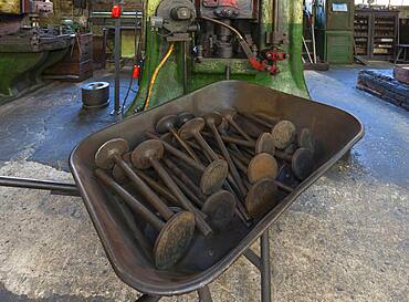 Car valves in the raw state in a wheelbarrow in front of a screw press in a drop forge, Industrial Museum, Lauf an der Pegnitz, Middle Franconia, Bavaria, Germany, Europe