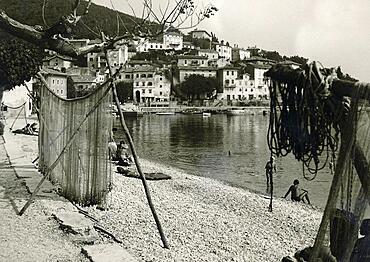 Yugoslavia in 1959: Moscenicka Draga beach with suspended fishing nets, Istria, Croatia, Europe