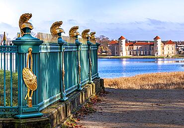 Restored fence with gold helmets at the Lake Grienerick obelisk in Rheinsberg, Rheinsberg, Brandenburg, Germany, Europe