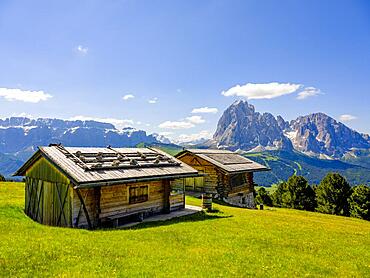 Alpine huts, Sella Group and Sassolungo in the background, Dolomites, South Tyrol, Italy, Europe