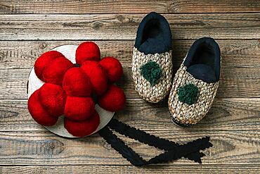 Original Black Forest Bollen hat with straw shoes on wooden background, Black Forest, Baden-Wuerttemberg, Germany, Europe