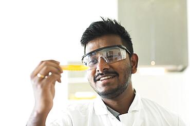 Student in an internship at the university with sample and lab coat, Freiburg, Baden-Wuerttemberg, Germany, Europe