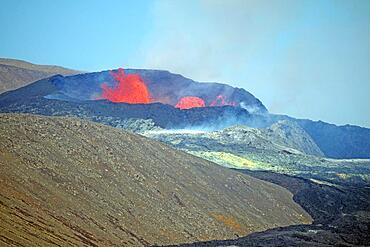 Sulphur fields and lava fields in front of volcanic craters, glowing lava fountains, steam and shimmering air Fagradal Falls, Reykjanes, Grindavik, Iceland, Europe