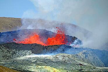 Sulphur fields in front of volcanic craters, glowing lava fountains, steam and shimmering air Fagradal Falls, Reykjanes, Grindavik, Iceland, Europe