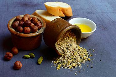 Dukkah, Arabic spice mixture in clay pots, nuts and bowls with olive oil