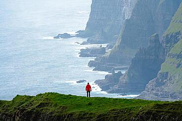 A person standing in the distance off the Beinisforo coast, Vagur, Suduroy, Faro Islands