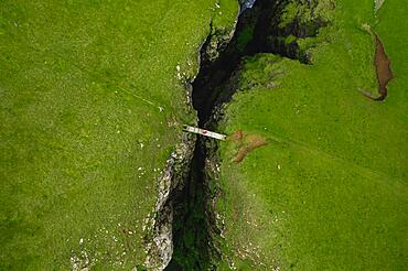 Aerial view, a person standing on a small wooden bridge, Sandvik, Suduroy, Faroe Islands, Europe