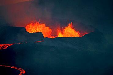 Glowing lava fountains, partially flowing down mountainside, night shot, Fagradalsfjall, Reykjanes, Grindavik, Sudurnes, Iceland, Europe