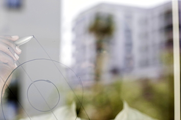 Young black man reconsiders a vision at the window with pen and great innovation, Freiburg, Baden-Wuerttemberg, Germany, Europe