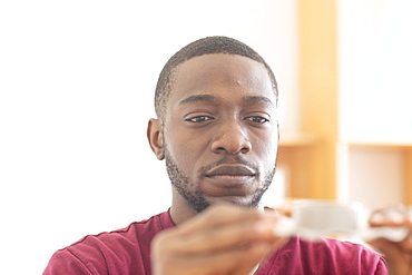 Young black man with sample reconsiders a vision or innovation in the office, Freiburg, Baden-Wuerttemberg, Germany, Europe