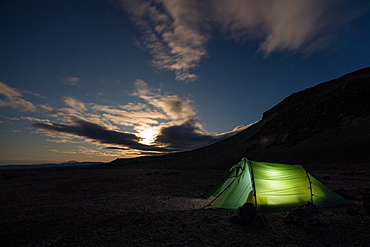 Tent lit from inside, moonrise, Askja volcano, Icelandic highlands, Iceland, Europe