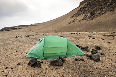 Green tent braced with lava rock, Askja volcano, Icelandic highlands, Iceland, Europe