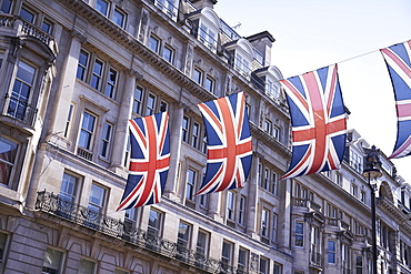 Union Jack flagging over street with old buildings, London, England, United Kingdom, Europe