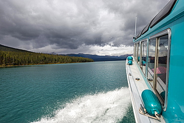 On a tourist boat, boat sailing on a lake, Maligne Lake, cloudy sky, Jasper National Park, Rocky Mountains, Alberta, Canada, North America