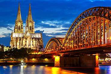 Cologne Cathedral Skyline and Hohenzollern Bridge with Rhine River in Germany at night in Cologne, Germany, Europe