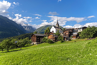 Village scene with the parish church of St. George, in the background the Wannenhorn group and the Risihorn, Ernen, Valais, Switzerland, Europe