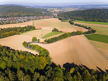 Drone shot, curve in autumnal forest, Roter Berg, L485, between Diekholzen and Sibbesse, in the background Diekholzen, district of Hildesheim, Lower Saxony, Germany, Europe