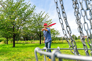 Man throwing a disc at Discgolf, also Disc Golf, Volkspark Potsdam, Potsdam, Brandenburg, Germany, Europe