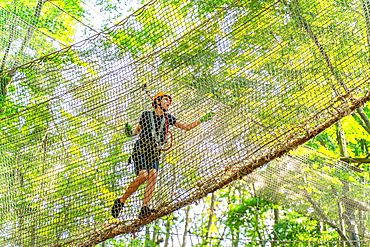 Boy climbing in a net in the climbing forest and high ropes course, Potsdam Adventure Park, Potsdam, Brandenburg, Germany, Europe