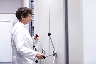 Technician working in a laboratory archive, Freiburg, Baden- Wuerttemberg, Germany, Europe