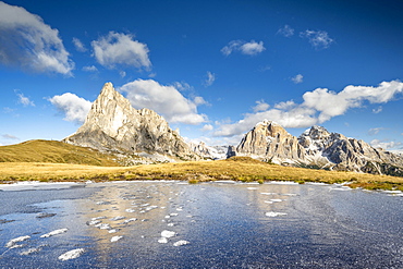 Frozen mountain lake in front of peak La Gusela at Passo Giau, Dolomites, Veneto, Italy, Europe