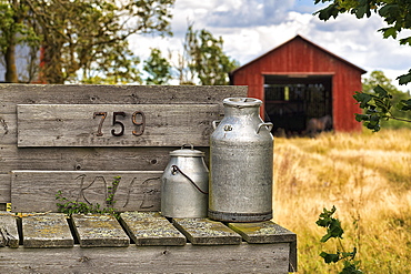 Two milk cans in front of a farm, ready for collection, Gotland, Sweden, Europe