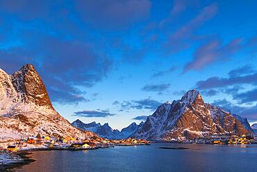 Winter Scandinavian landscape at sunrise, sea, mountains, snow, Reine, Nordland, Lofoten, Norway, Europe