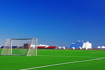 Football ball with goals in front of icebergs, artificial turf, Disko Island, Disko Bay, Qeqertarsuaq, Arctic, Greenland, Denmark, North America