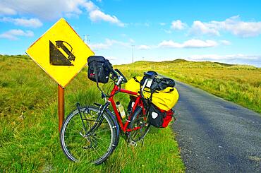 Bicycle in front of road sign warning of steep gradient, Connemara, Ireland, Europe