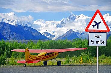 Traffic sign warning of aircraft, small plane in the mountains, glacier, Alaska, USA, North America