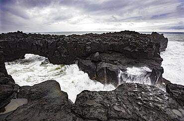 Lava arch on the volcanic coast at high tide with high waves, Ponta da Ferraria, Sao Miguel Island, Azores, Portugal, Europe