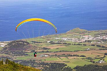 Paragliders after take-off from Pico Barrosa with a view over the island of Sao Miguel, Azores, Portugal, Europe