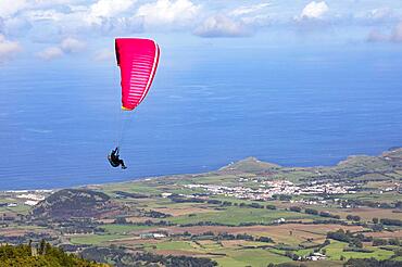 Paragliders after take-off from Pico Barrosa with a view over the island of Sao Miguel, Azores, Portugal, Europe