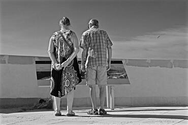 Man and woman in front of information board at castle, San Juan de los Terreros, Andalusia, Spain, Europe